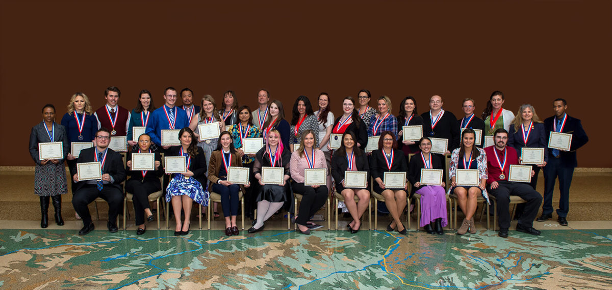 large group photo of the 2018 PTK group with medals and certificates