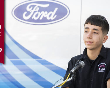 Pueblo Community College student speaking in front of Ford truck.