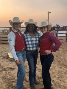 Dr Lisa Jones with two students at a rodeo
