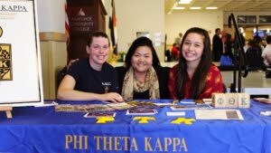 Leah Porter, center, poses with two Phi Theta Kappa members at Arapahoe Community College.