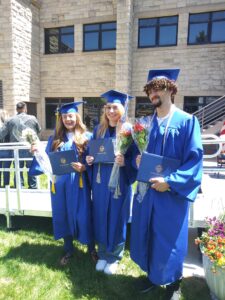 Three Second Chance Pell Grant recipients hold their diplomas